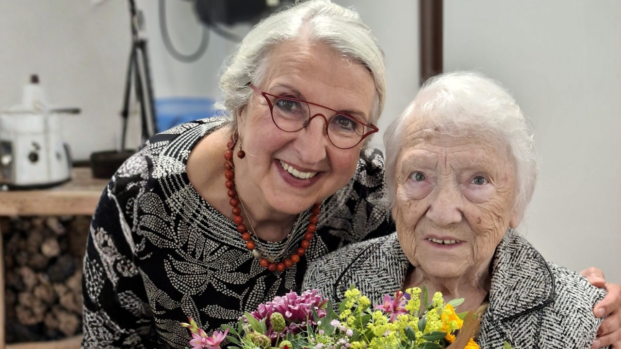 Zwei ältere Frauen mit einem Blumenstrauß