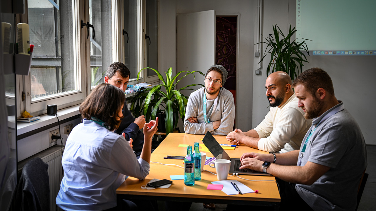 Gruppe junger Erwachsener arbeitet am Tisch