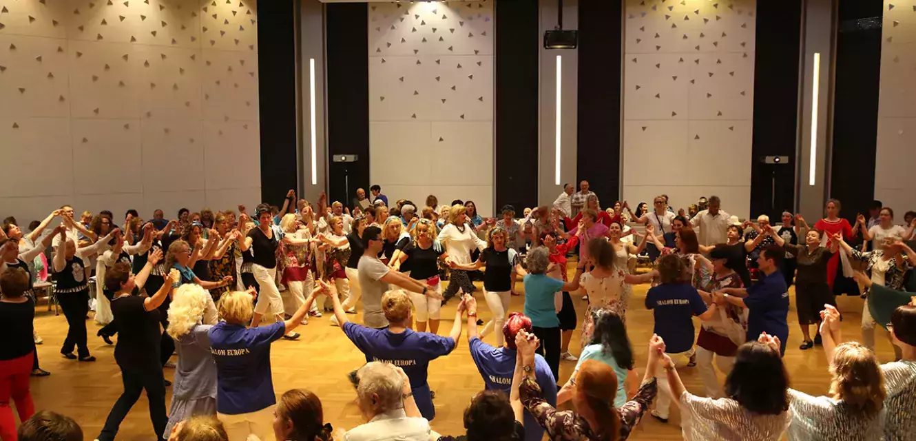 Viele tanzende Menschen in einem großen Saal 